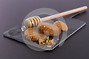 Honey and Cookies on a cardboard shale on a Black Background