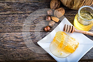 honey dipper and honeycomb, nuts of various kinds