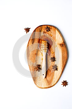 Honey dipper on a wooden board