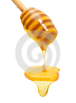 Honey drip from wooden dipper isolated