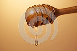 Honey dripping on gold color background