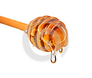 Honey dripping from honey dipper isolated on white