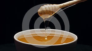 Honey dripping isolated on black