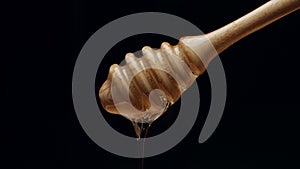 Honey dripping isolated on black