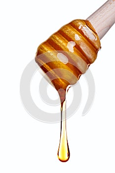 Honey dripping from a wooden dipper