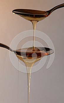 Honey drizzling off spoons