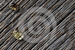 Honey drops close-up on textured wooden boards background
