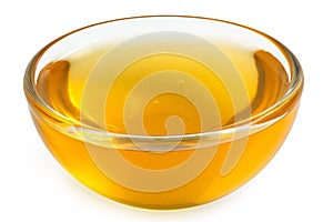 Honey in a glass bowl isolated on white