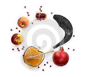 Honey in glass bowl, red apples, garnets, shofar  horn  on a white background with space for text. Top view, flat lay. Symbol