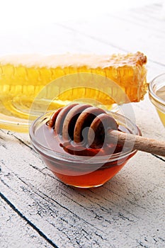 Honey in glass with honey dipper, Honeycomb, Honey Bee.