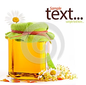 Honey in glass jar with flowers