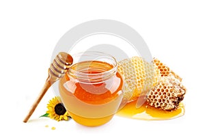 Honey in glass jar and honeycombs wax