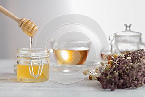 Honey in glass jar and honeycombs wax
