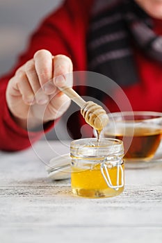 Honey in glass jar and honeycombs wax