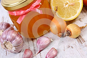 Honey in glass jar, onion, lemon and garlic, healthy nutrition and strengthening immunity