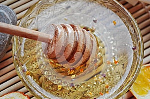 Honey and honey spoon immersed in honey