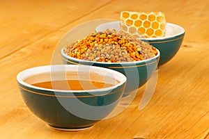 Honey, honeycomb and pollen in bowls