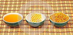 Honey, honeycomb and pollen in bowls