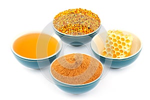 Honey, honeycomb, pollen and cinnamon in bowls