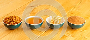 Honey, honeycomb, pollen and cinnamon in bowls