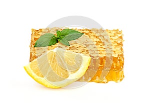 Honey in honeycombs with lemon and mint.