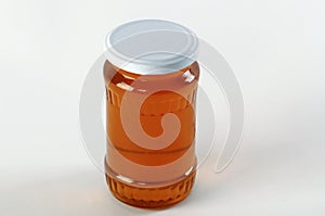 Honey jar. Honey tidbit in glass jar and honeycombs wax.