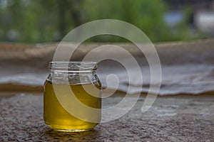 Honey in jar and window with green on backcground