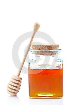 Honey jar and wooden drizzler photo