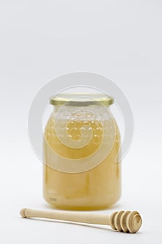 Honey jar and wooden honey spoon