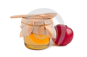 Honey in jar wooden spoon.