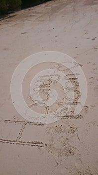 Honey moon handwritting on the sand. Stock photo.