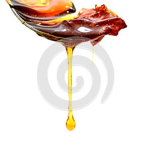 Honey mustard sauce. Splashes and spilled salad dressing with spoon isolated on white background. Top view.