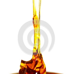 Honey mustard sauce. Splashes and spilled salad dressing with spoon isolated on white background. Top view.