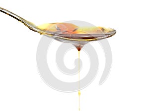 Honey mustard sauce. Splashes and spilled salad dressing with spoon isolated on white background. Top view.