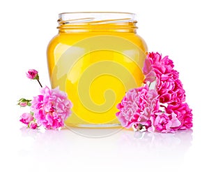 Honey in open glass jar and flowers isolated on white background