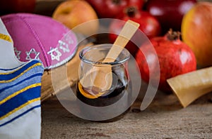 Honey on the pomegranate and apples. Jewish new year Rosh Ha Shana kippah yamolka and shofar