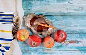 Honey on the pomegranate and apples. Jewish new year Yom Kippur and Rosh Hashanah kippah yamolka and shofar