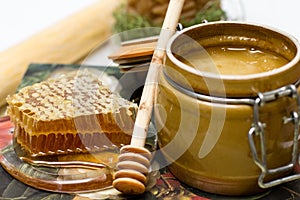 Honey in pot, honeycomb and stick