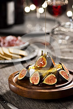 Honey Poured Over Brie Cheese and Figs at Festive Party