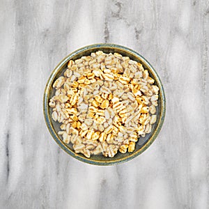 Honey puffed wheat in a bowl on a marble tabletop