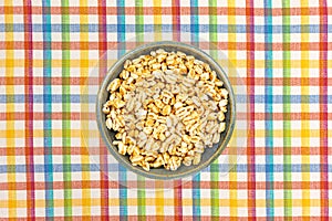 Honey puffed wheat in a bowl on a placemat