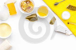 Honey spa set with natural honey, soap, cream, towel and pumice stone on white background top view space for text