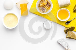 Honey spa set with natural honey, soap, cream, towel and pumice stone on white background top view space for text