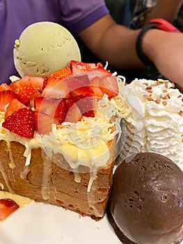 Honey toast with chocolate ice cream and green tea ice cream decoration with strawberry