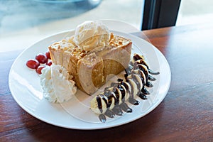 Honey toast with vanilla ice cream, whipped cream and chocolate syrup