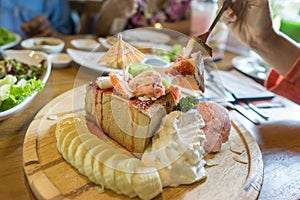 honey toasts with strawberry, banana and vanilla ice-cream on wooden table