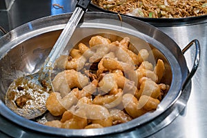 Asian shrimp in honey walnut sauce served in metal wok