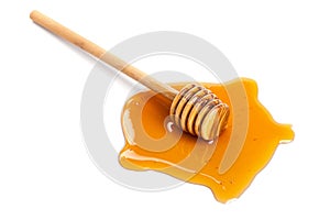 Honey and wooden dipper isolated