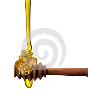 Honey on a wooden dipper isolated on white background with clipping path
