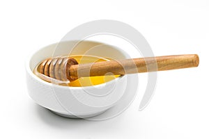Honey with wooden honey dipper isolated on white, horizontal